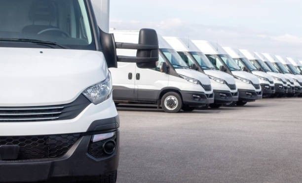 Fleet of commercial vehicles parked in a yard